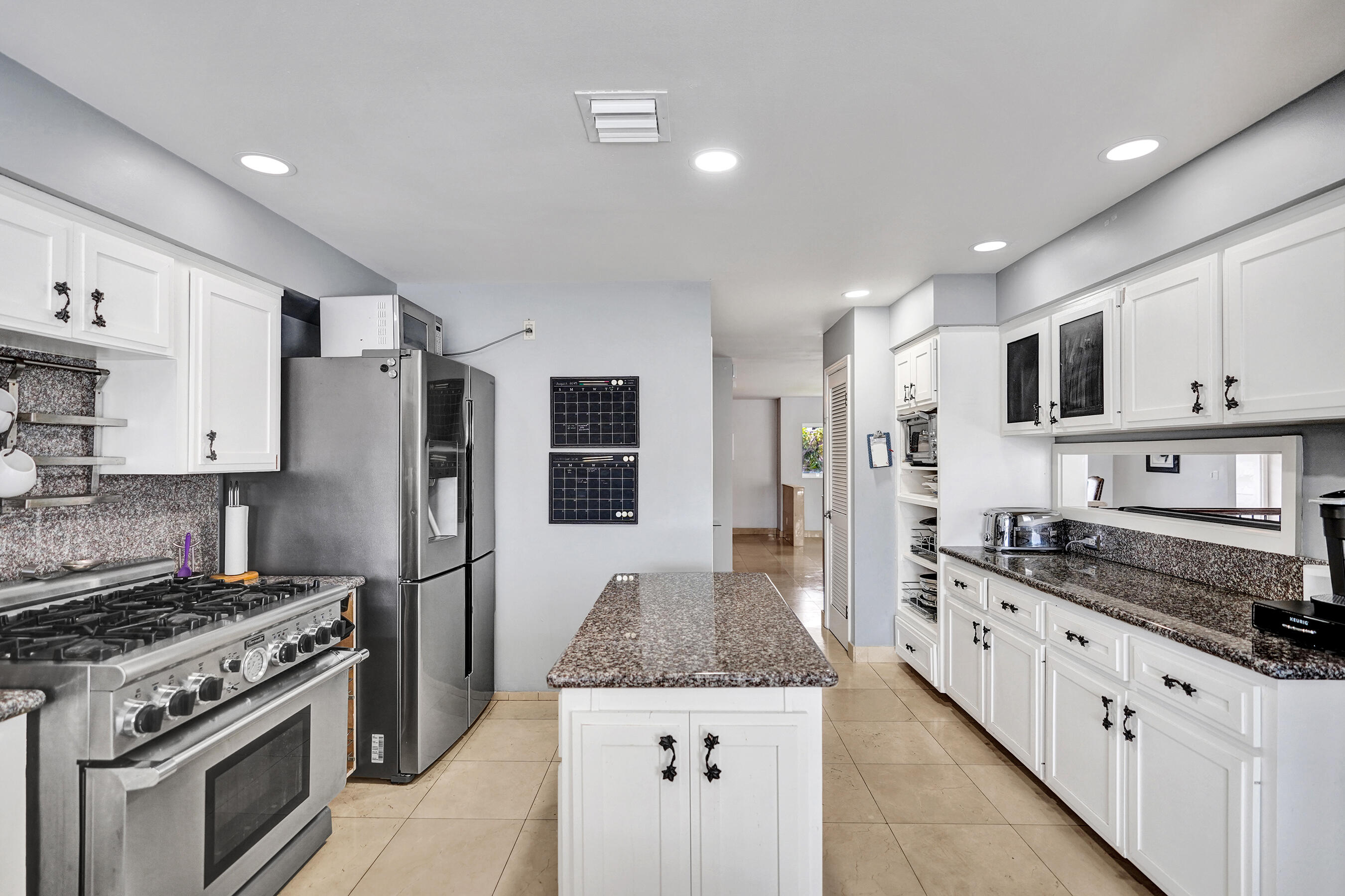 3001 Northeast 47th Street Lighthouse Point, FL 33064 - Photo 14 of 39 a large kitchen with stainless steel appliances granite countertop a stove and a refrigerator