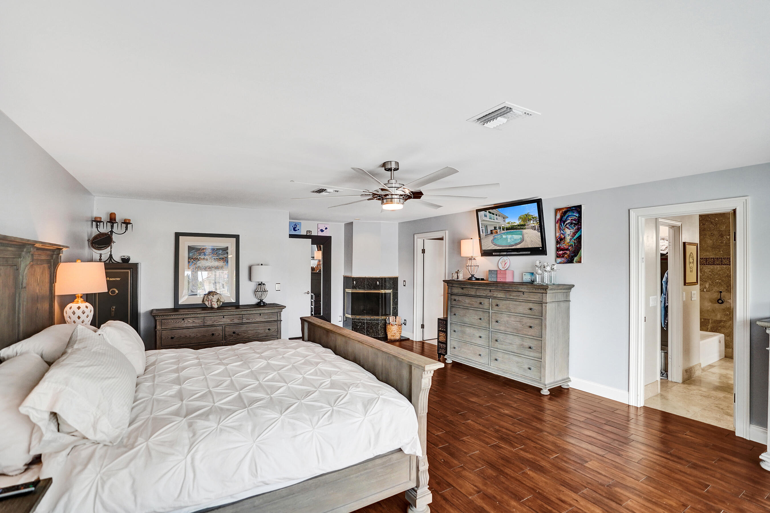 3001 Northeast 47th Street Lighthouse Point, FL 33064 - Photo 16 of 39 a bedroom with a bed and ceiling fan