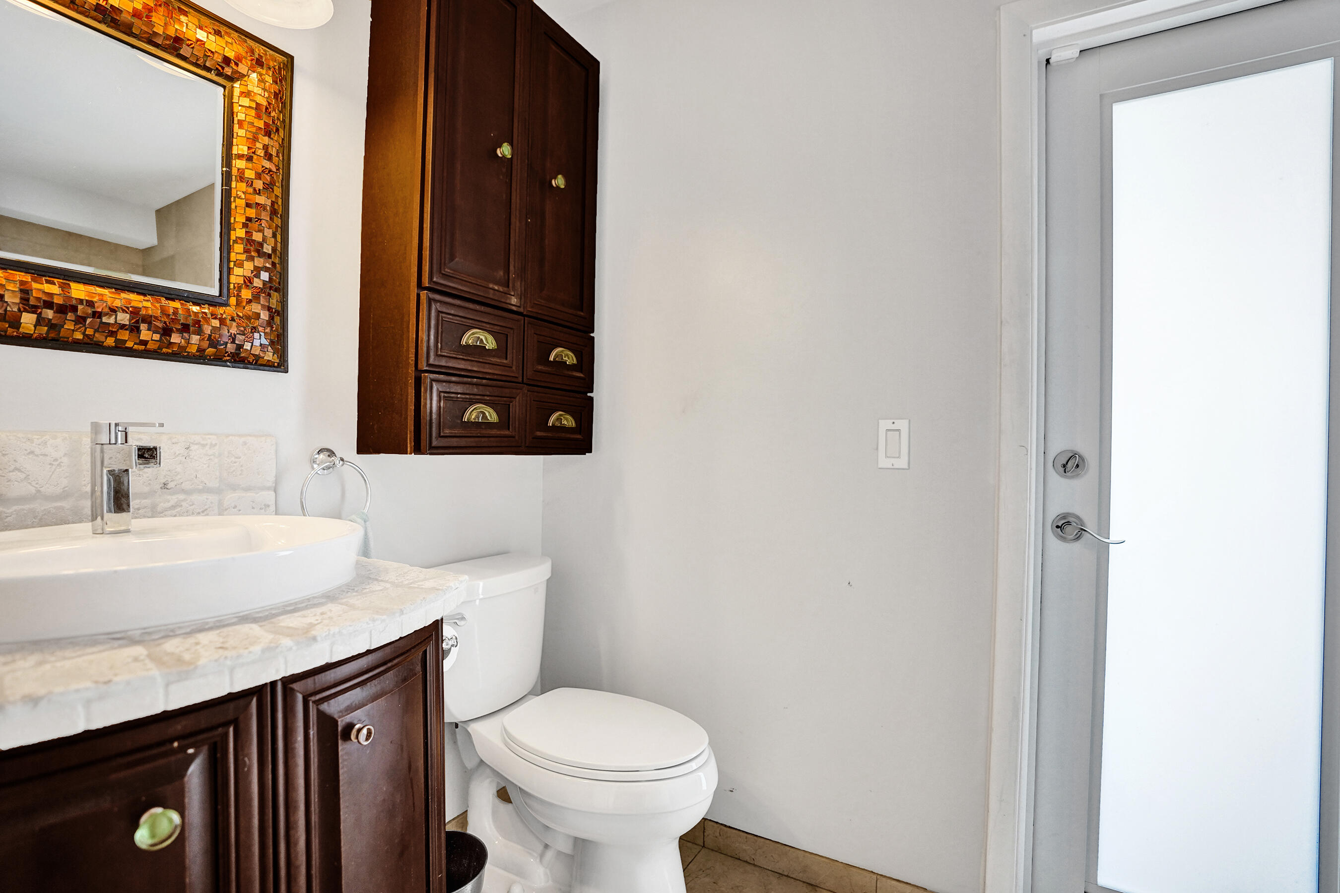 3001 Northeast 47th Street Lighthouse Point, FL 33064 - Photo 24 of 39 a bathroom with a sink and a toilet