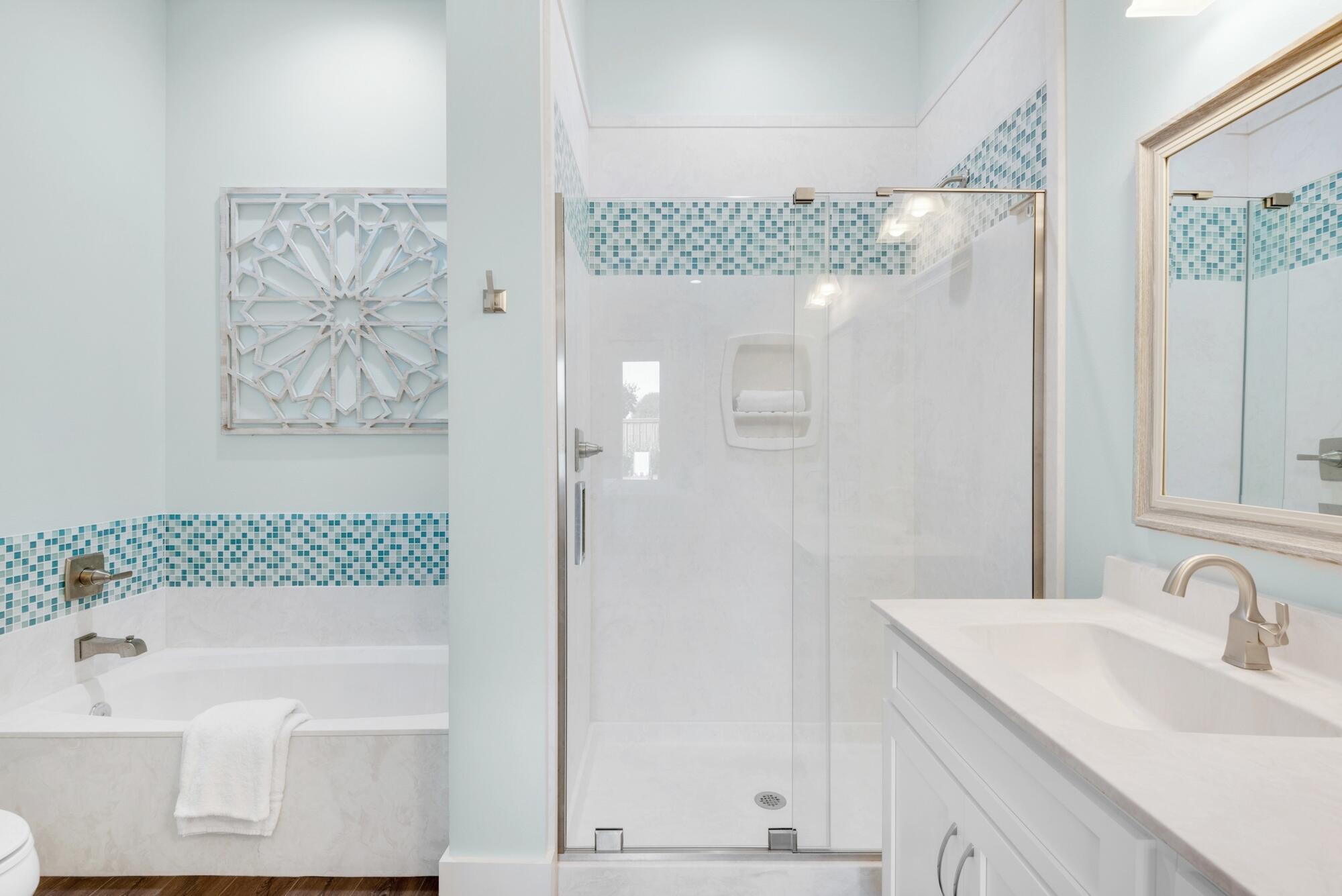 4563 Luke Avenue Destin, FL 32541 - Photo 15 of 37 a bathroom with a bathtub and a shower
