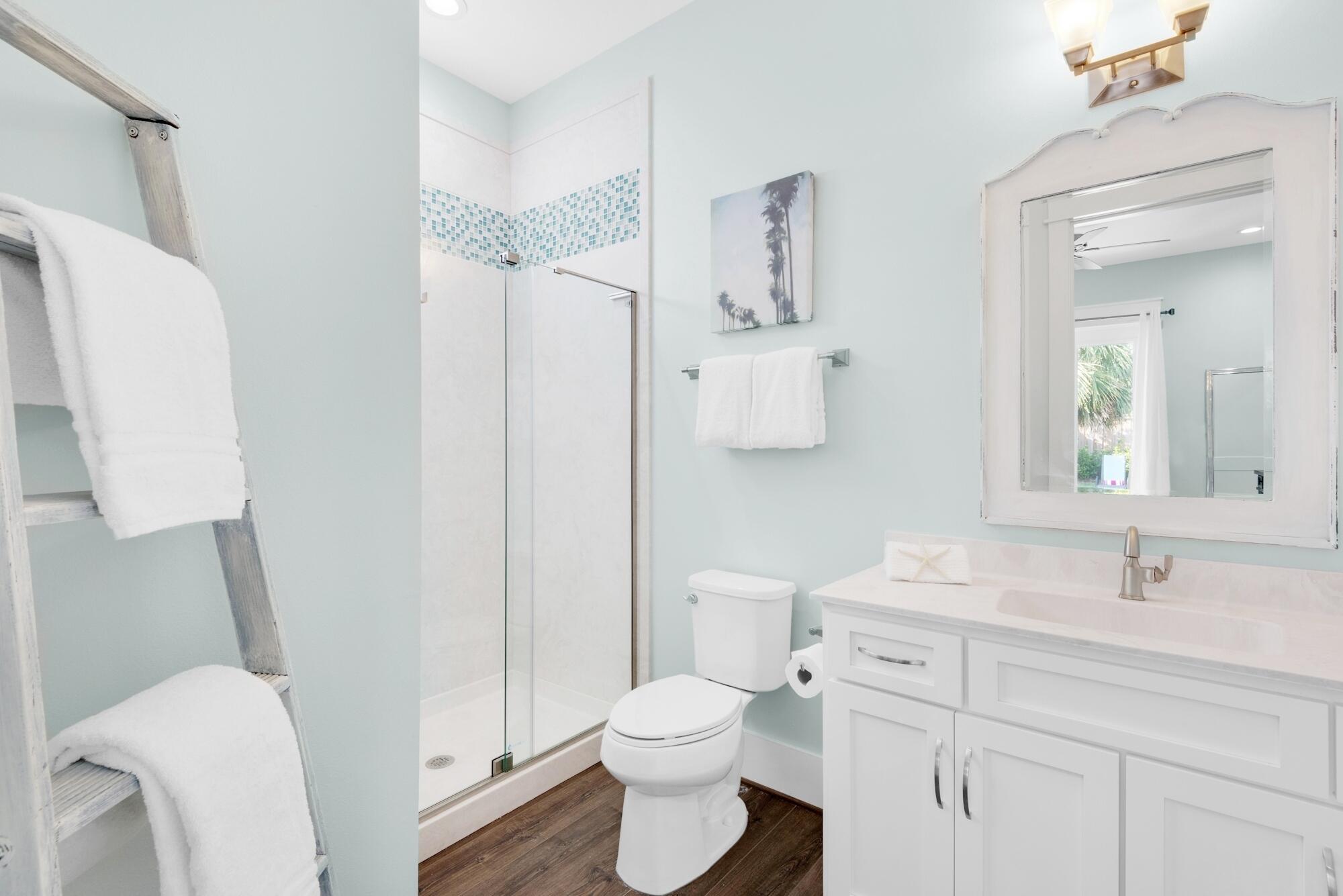 4563 Luke Avenue Destin, FL 32541 - Photo 18 of 37 a bathroom with a toilet sink vanity and mirror