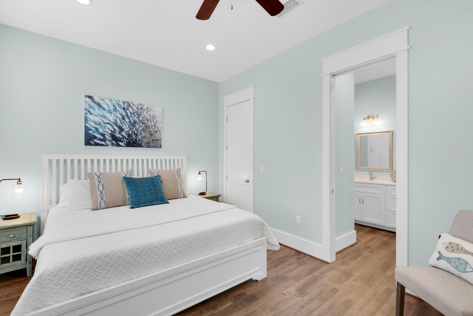 4563 Luke Avenue Destin, FL 32541 - Photo 21 of 37 a bedroom with a large bed and a chandelier