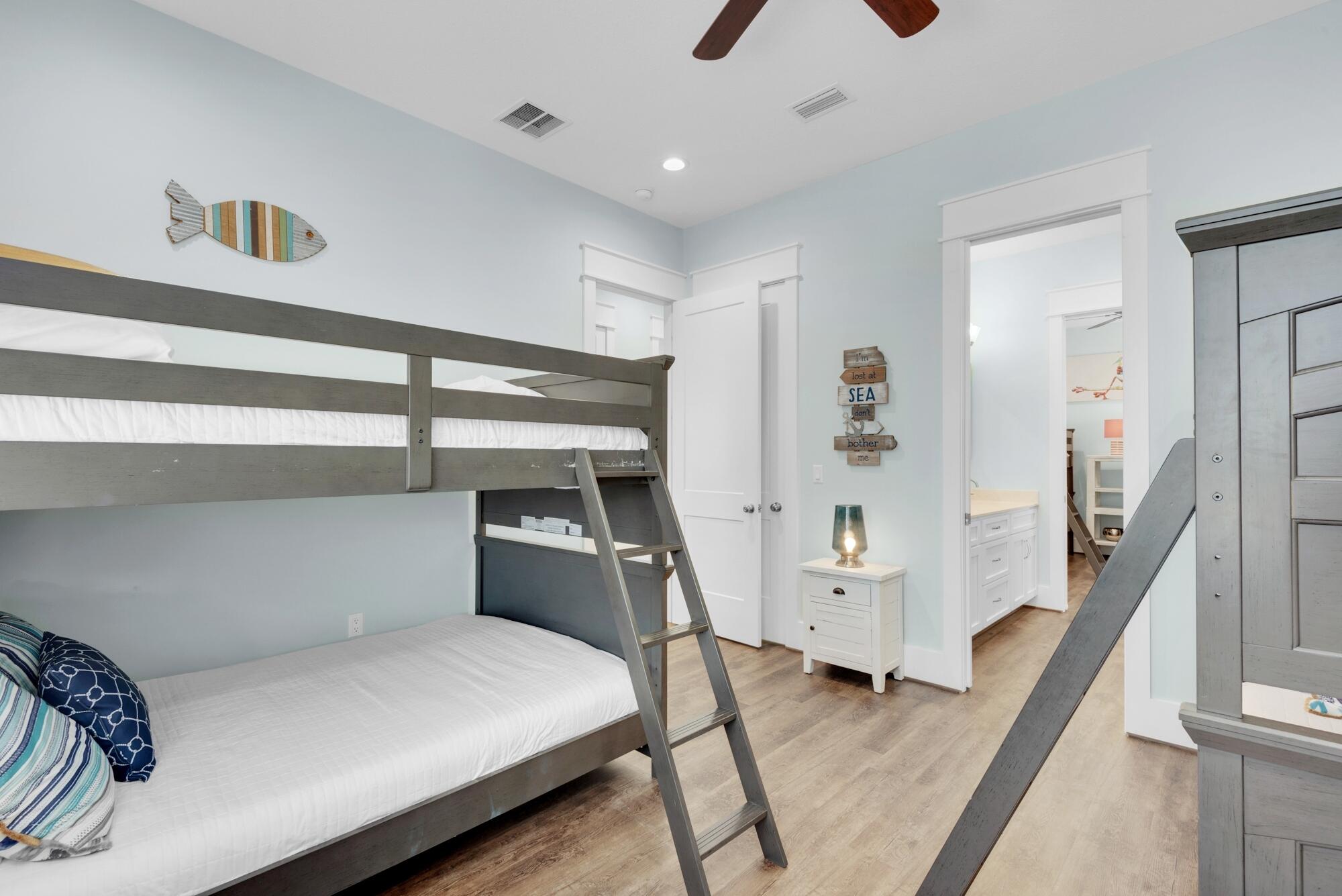 4563 Luke Avenue Destin, FL 32541 - Photo 28 of 37 a bedroom with a bed and a large mirror on the dresser