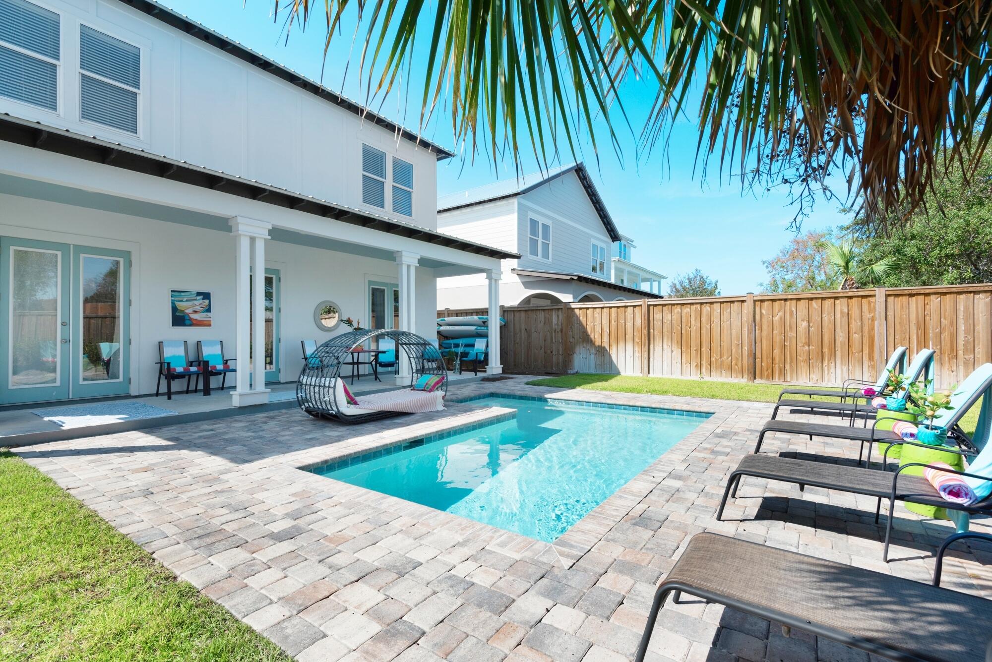 4563 Luke Avenue Destin, FL 32541 - Photo 34 of 37 a view of a backyard with couches plants and large tree
