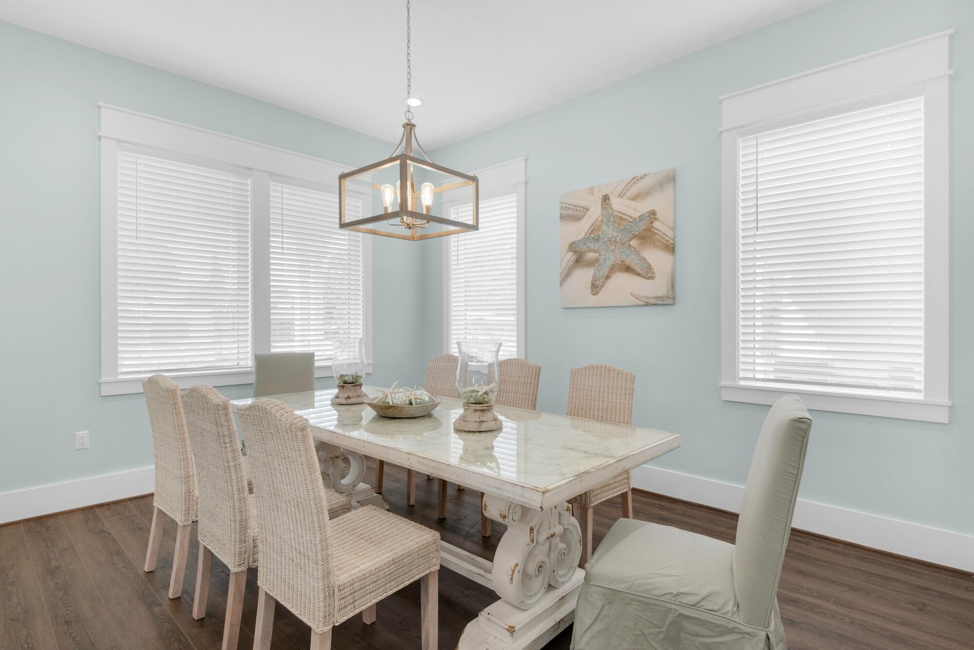 4563 Luke Avenue Destin, FL 32541 - Photo 9 of 37 a view of a dining room with furniture wooden floor and a chandelier