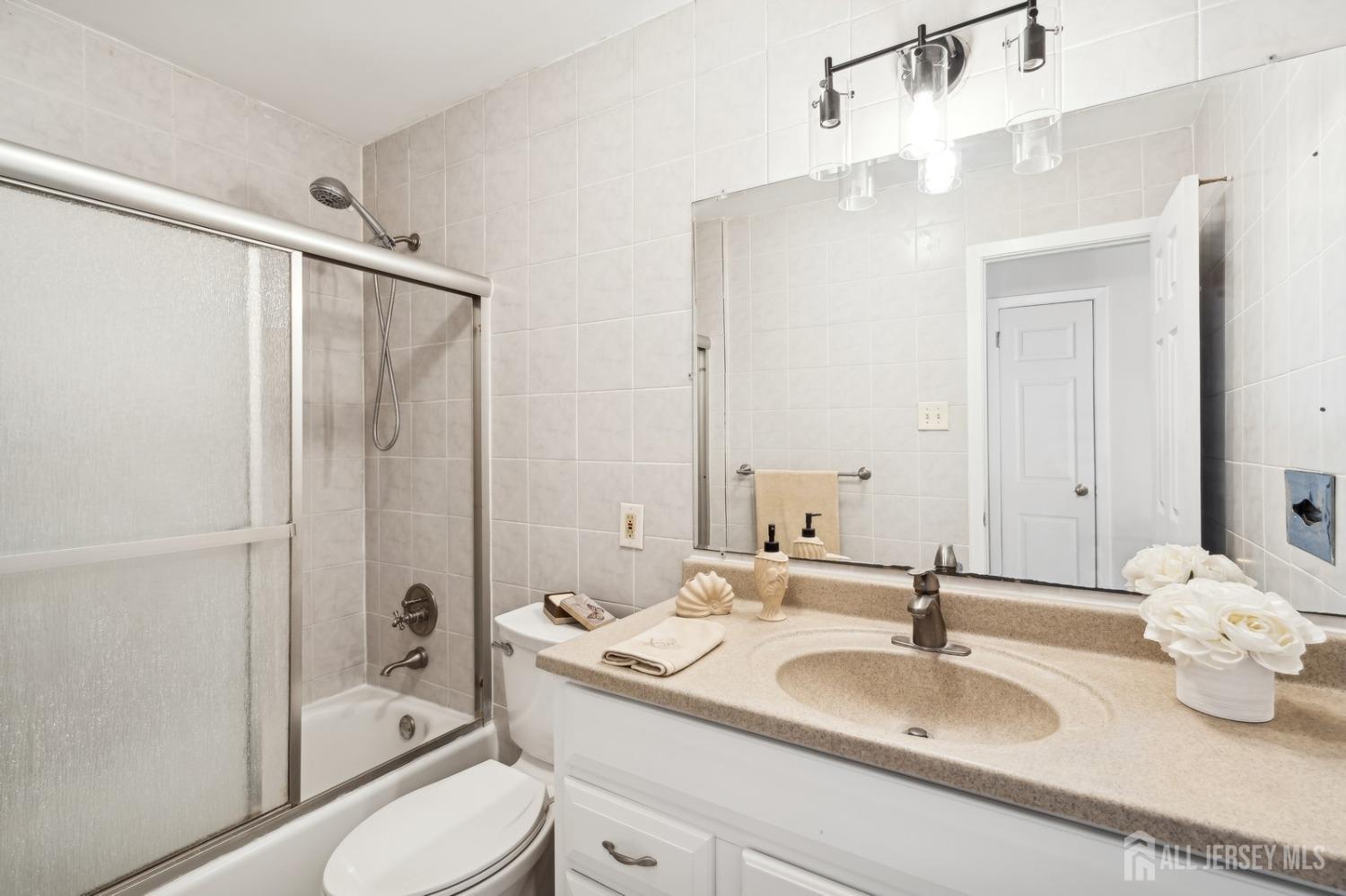 12 Midland Road Edison, NJ 08820 - Photo 6 of 7 a bathroom with a granite countertop sink toilet and shower
