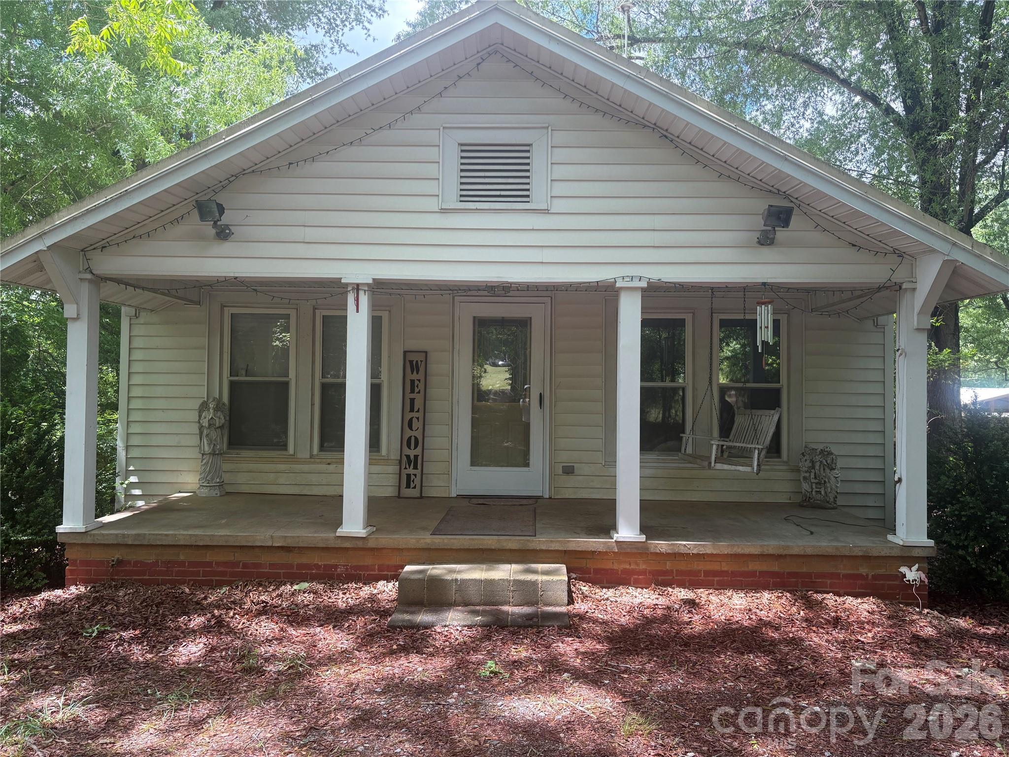 3880 Love Road Claremont, NC 28610 - Photo 1 of 14 a view of a white house with a large window and yard