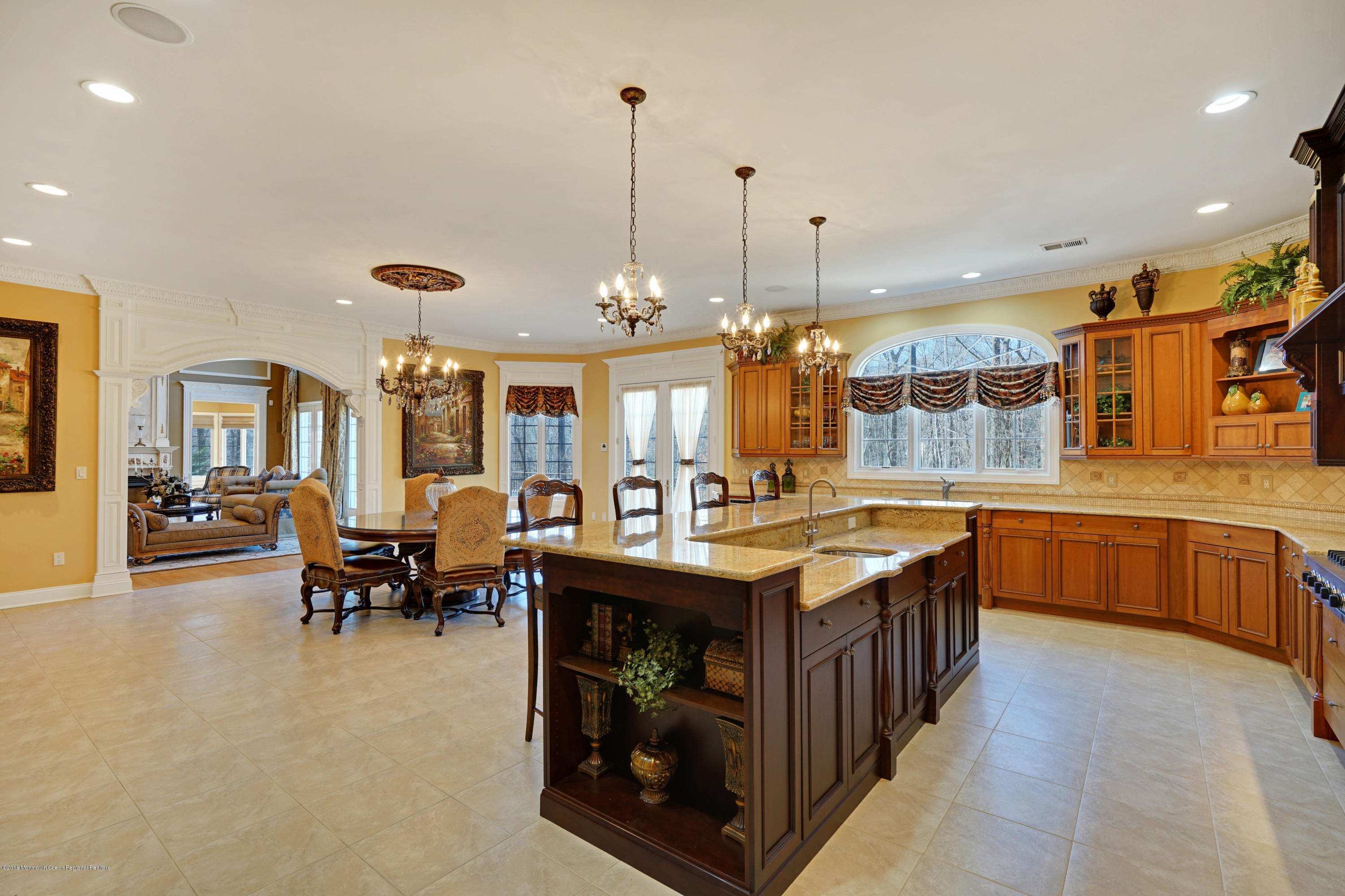 21 Embry Farm Road Marlboro, NJ 07746 - Photo 16 of 68 a kitchen with stainless steel appliances granite countertop a stove a sink a dining table and chairs
