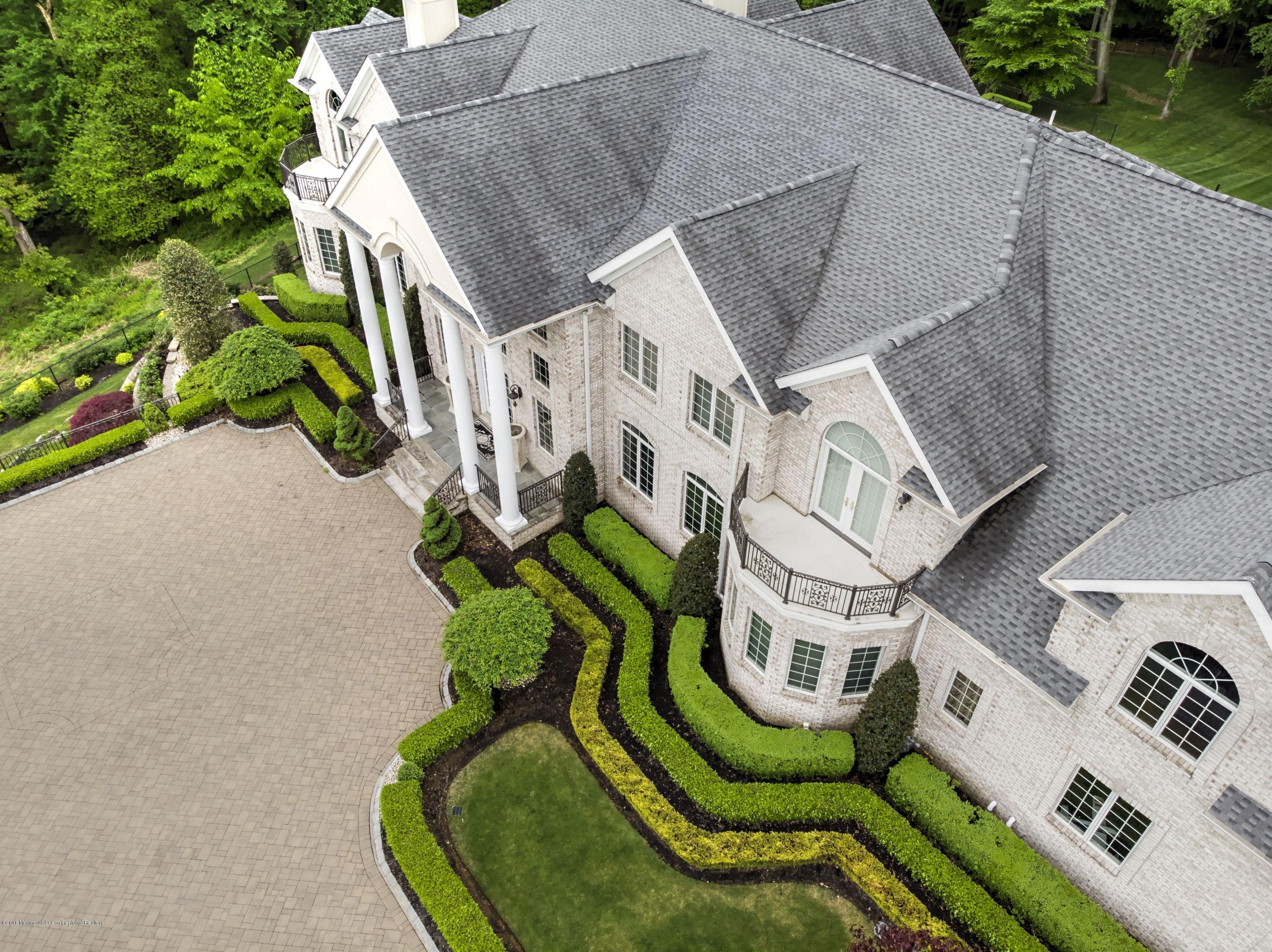 21 Embry Farm Road Marlboro, NJ 07746 - Photo 4 of 68 an aerial view of a house with swimming pool and garden