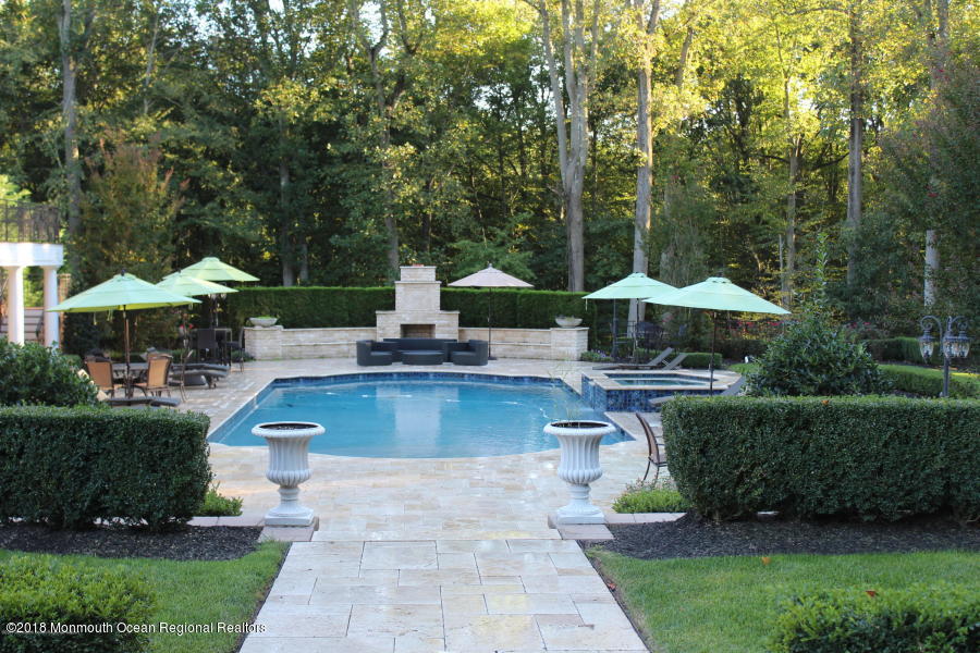21 Embry Farm Road Marlboro, NJ 07746 - Photo 57 of 68 a house view with a sitting space garden and swimming pool