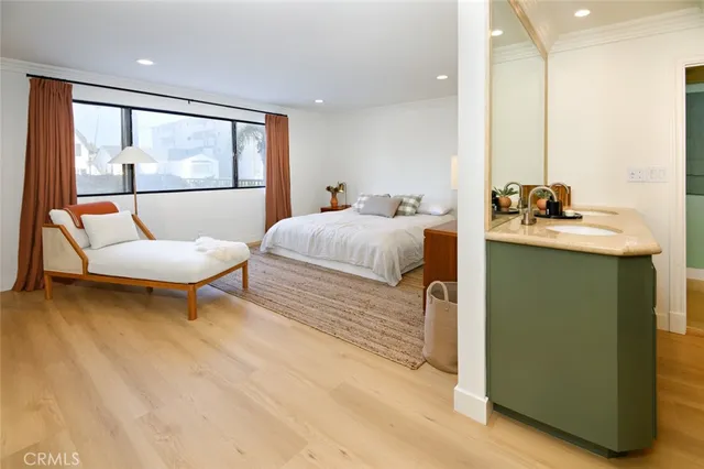 a bedroom with a bed and a dresser with mirror