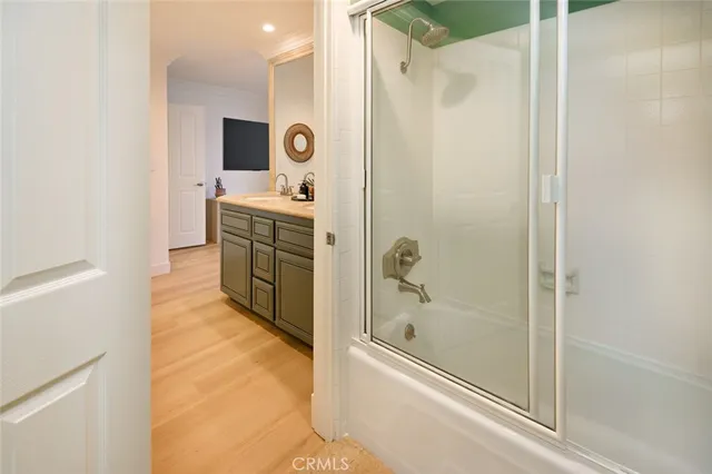 a bathroom with a granite countertop sink mirror and shower