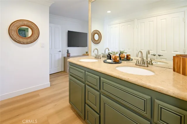 a bathroom with a granite countertop double vanity sink and a mirror