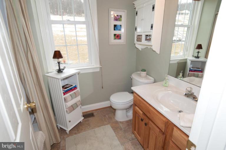 4265 Middlepoint Road Myersville, MD 21773 - Photo 2 of 25 a bathroom with a sink toilet and window