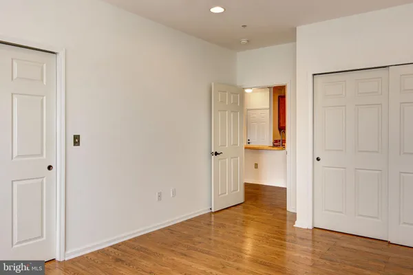 a view of an empty room with wooden floor