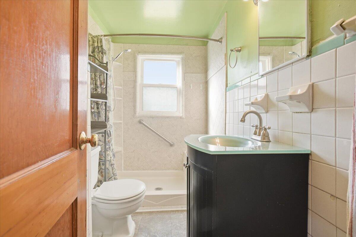 519 Bruffey Street Salem, VA 24153 - Photo 13 of 26 a bathroom with a granite countertop sink toilet and shower