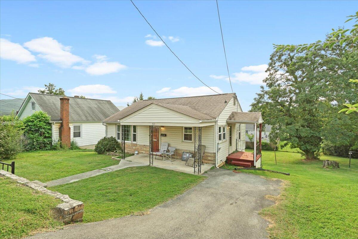 519 Bruffey Street Salem, VA 24153 - Photo 3 of 26 a front view of a house with a garden and trees