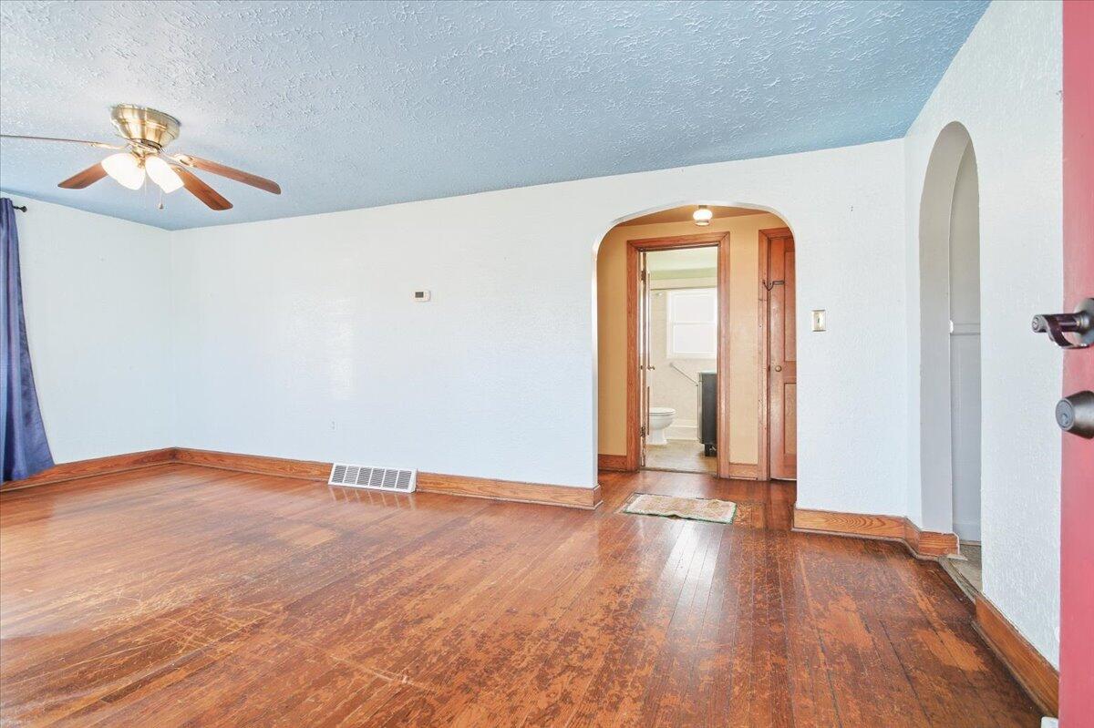 519 Bruffey Street Salem, VA 24153 - Photo 5 of 26 a view of empty room with wooden floor and fan