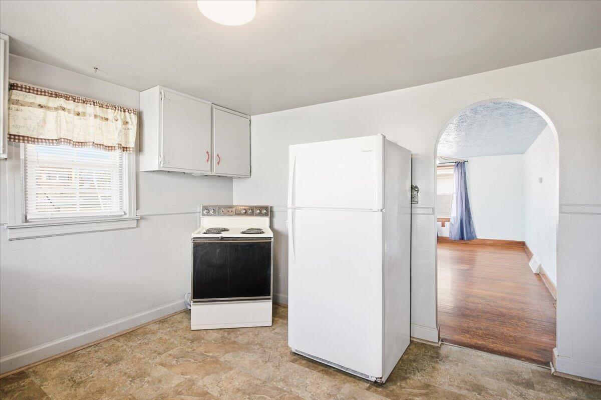 519 Bruffey Street Salem, VA 24153 - Photo 9 of 26 a view of a kitchen with a refrigerator a stove top oven and cabinets