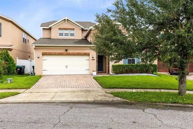 a front view of a house with a yard and garage