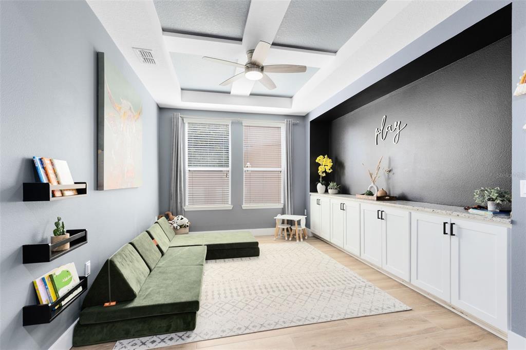 1048 Fountain Coin Loop Orlando, FL 32828 - Photo 12 of 39 a living room with furniture hard wood floor and a chandelier