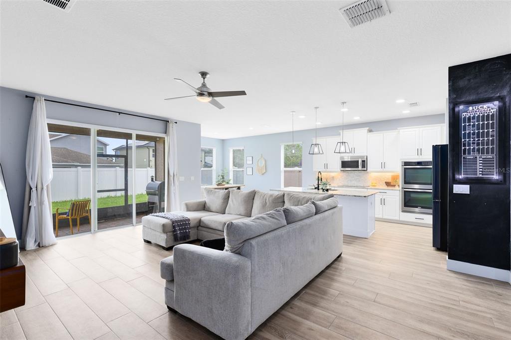 1048 Fountain Coin Loop Orlando, FL 32828 - Photo 13 of 39 a living room with furniture and a large window