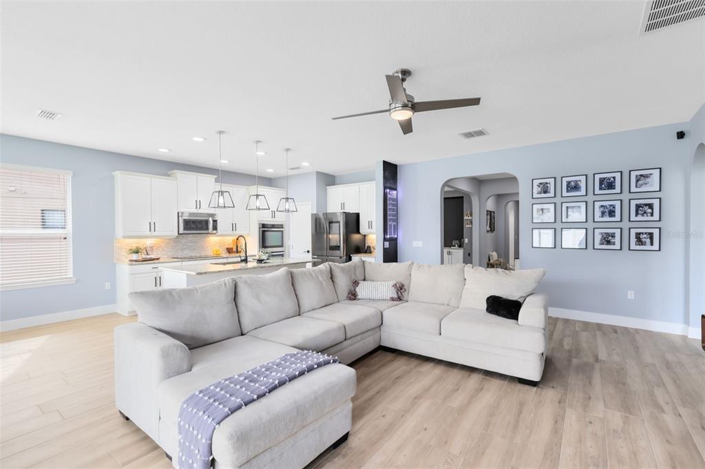 1048 Fountain Coin Loop Orlando, FL 32828 - Photo 15 of 39 a living room with furniture and a wooden floor