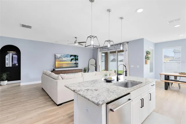 a kitchen with sink and living room