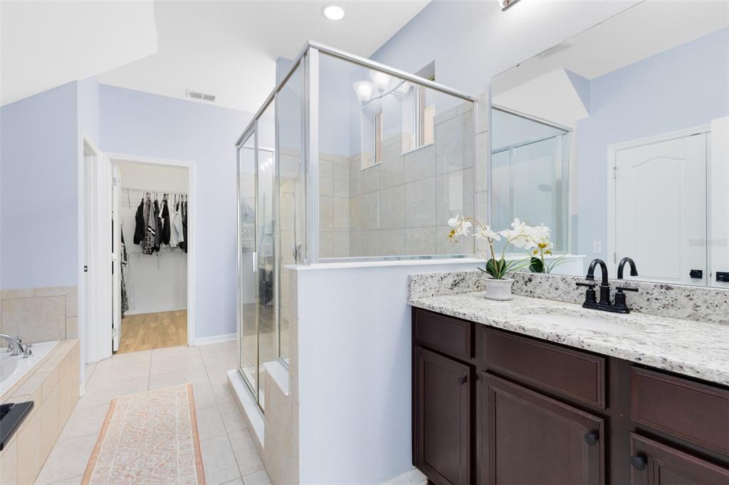 1048 Fountain Coin Loop Orlando, FL 32828 - Photo 21 of 39 a en suite bathroom with a granite countertop sink and mirror