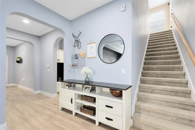 a view of a hallway with entryway wooden floor and front door