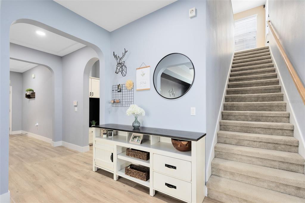1048 Fountain Coin Loop Orlando, FL 32828 - Photo 23 of 39 a view of a hallway with entryway wooden floor and front door