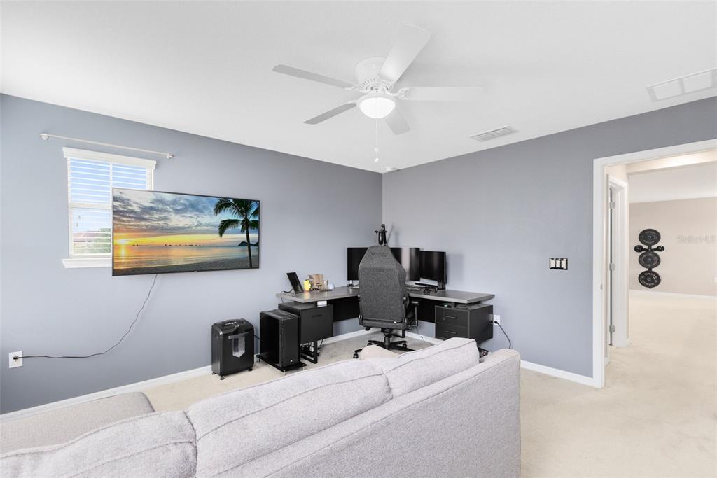 1048 Fountain Coin Loop Orlando, FL 32828 - Photo 29 of 39 a living room with furniture and a flat screen tv