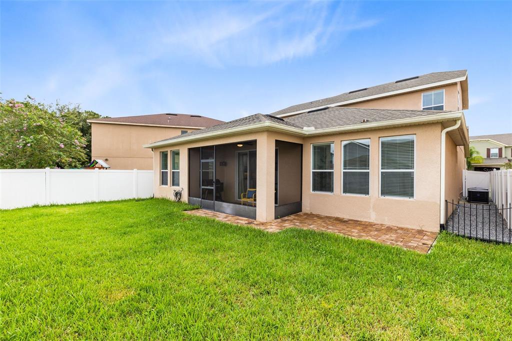 1048 Fountain Coin Loop Orlando, FL 32828 - Photo 32 of 39 a view of an house with backyard porch and garden