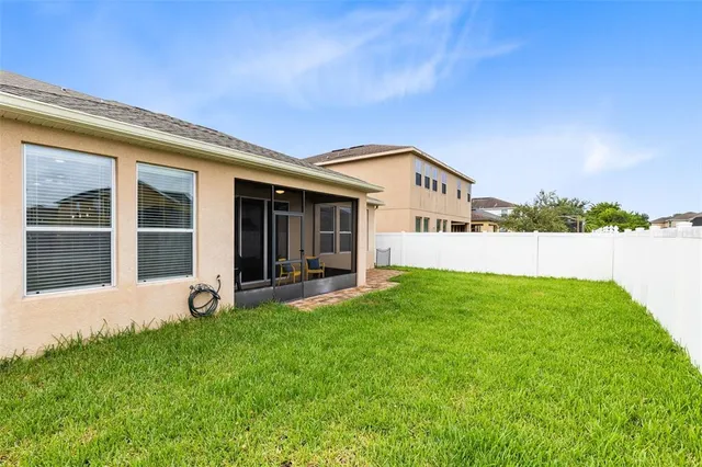 a view of a house with backyard garden and garden
