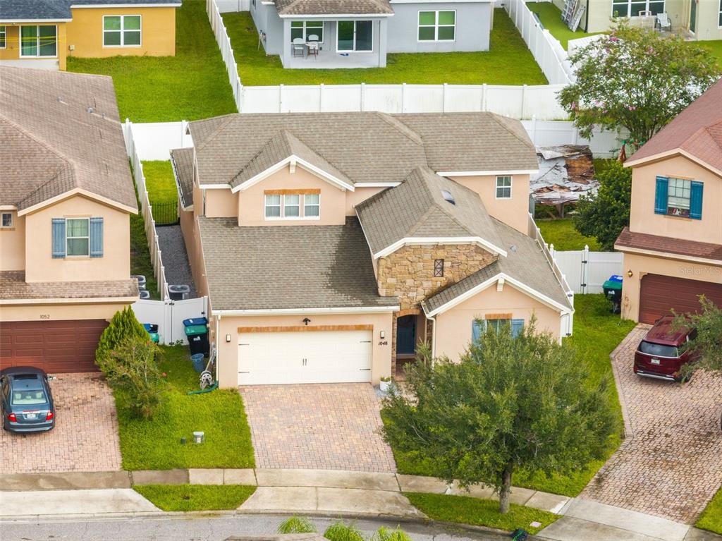 1048 Fountain Coin Loop Orlando, FL 32828 - Photo 39 of 39 an aerial view of a house with a yard and potted plants