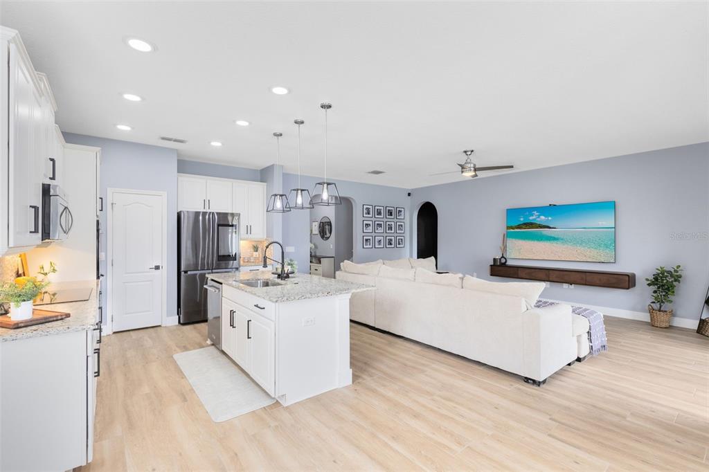 1048 Fountain Coin Loop Orlando, FL 32828 - Photo 4 of 39 a living room with stainless steel appliances furniture and a kitchen view