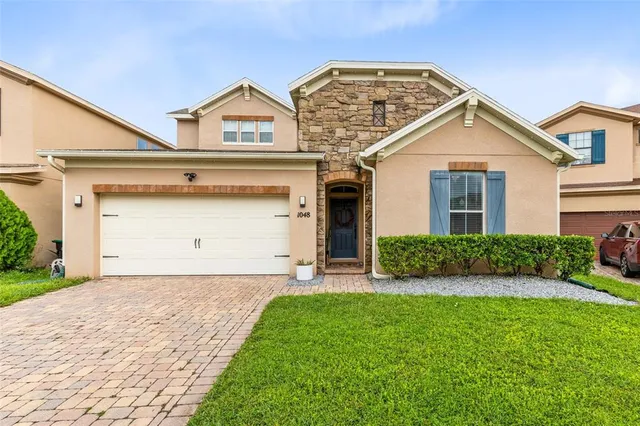 a view of a house with a yard and garage
