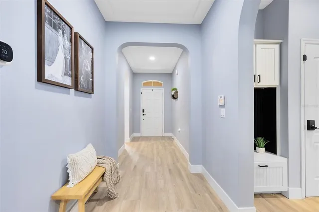 a view of a hallway with entryway wooden floor and front door