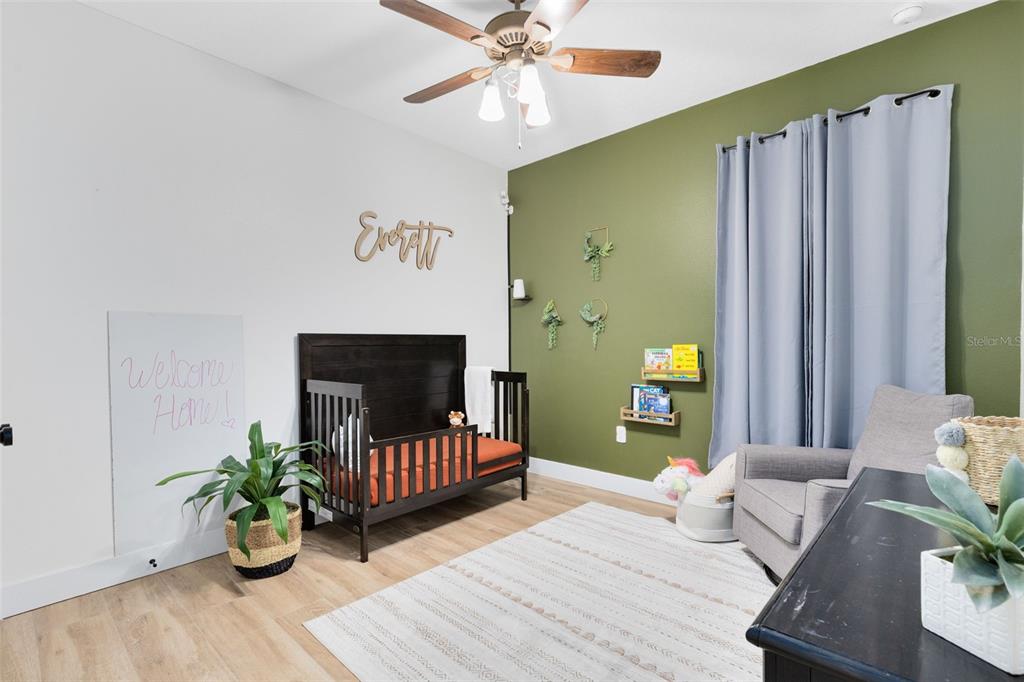 1048 Fountain Coin Loop Orlando, FL 32828 - Photo 10 of 39 a bedroom with a bed and ceiling fan