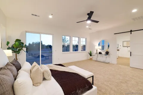 a bedroom with a bed and a large window