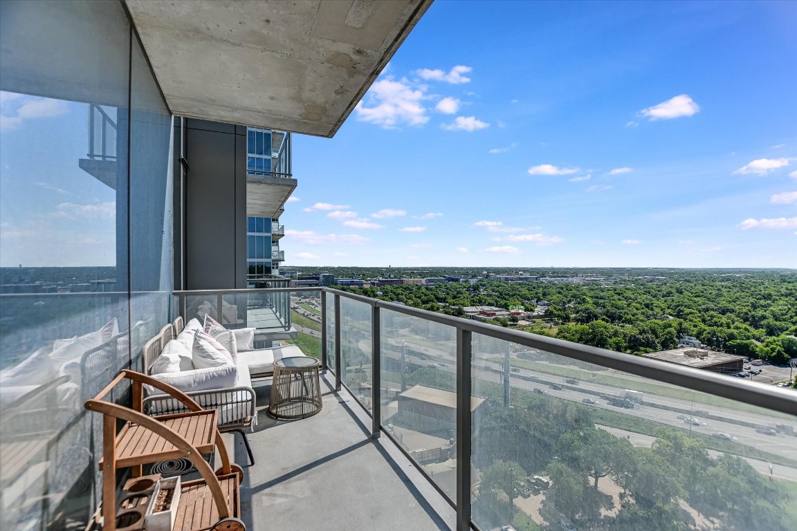 a view of a balcony with chair and table