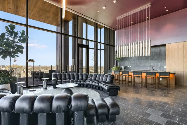 a living room with furniture and a floor to ceiling window