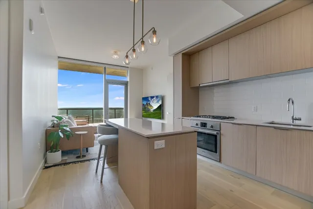 a kitchen with stainless steel appliances granite countertop a stove and a refrigerator