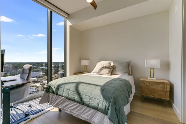a bedroom with a bed and wooden floor