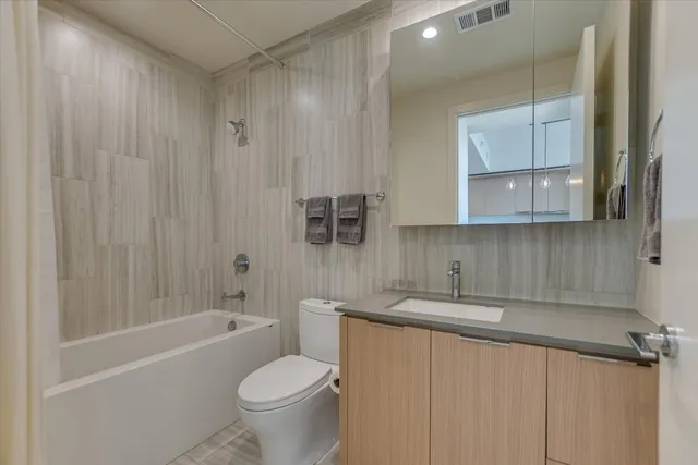 a bathroom with a sink a toilet and bathtub
