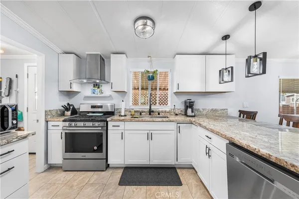 a kitchen with a stove sink and cabinets
