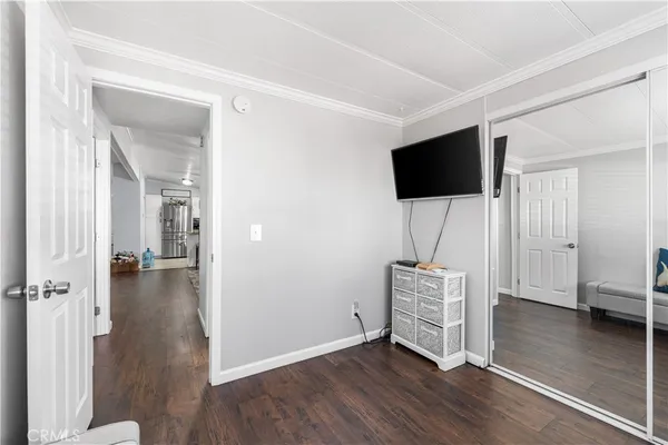 a view of a livingroom with wooden floor and a flat screen tv
