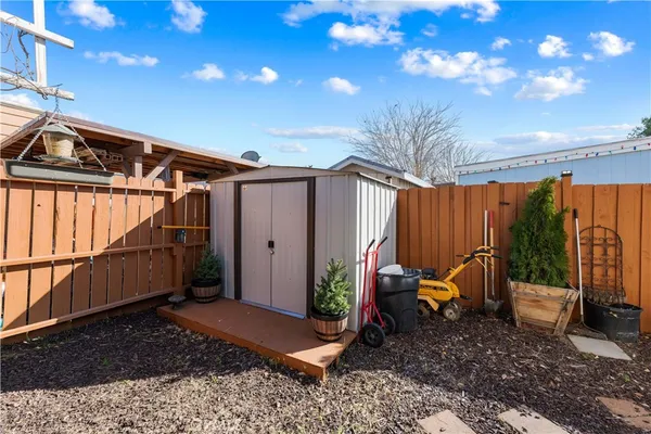a backyard of a house with barbeque oven table and chairs