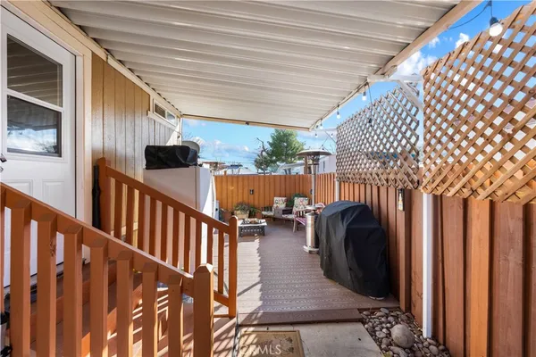 a view of a porch with furniture and wooden floor