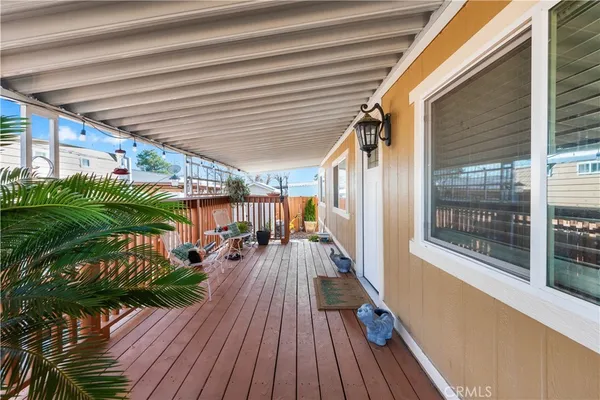 a view of a balcony with furniture and wooden floor